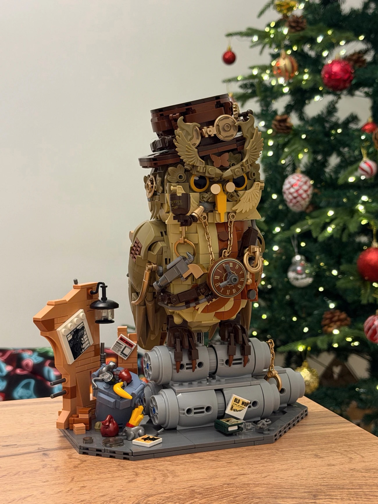 Mechanical owl model beside a Christmas tree