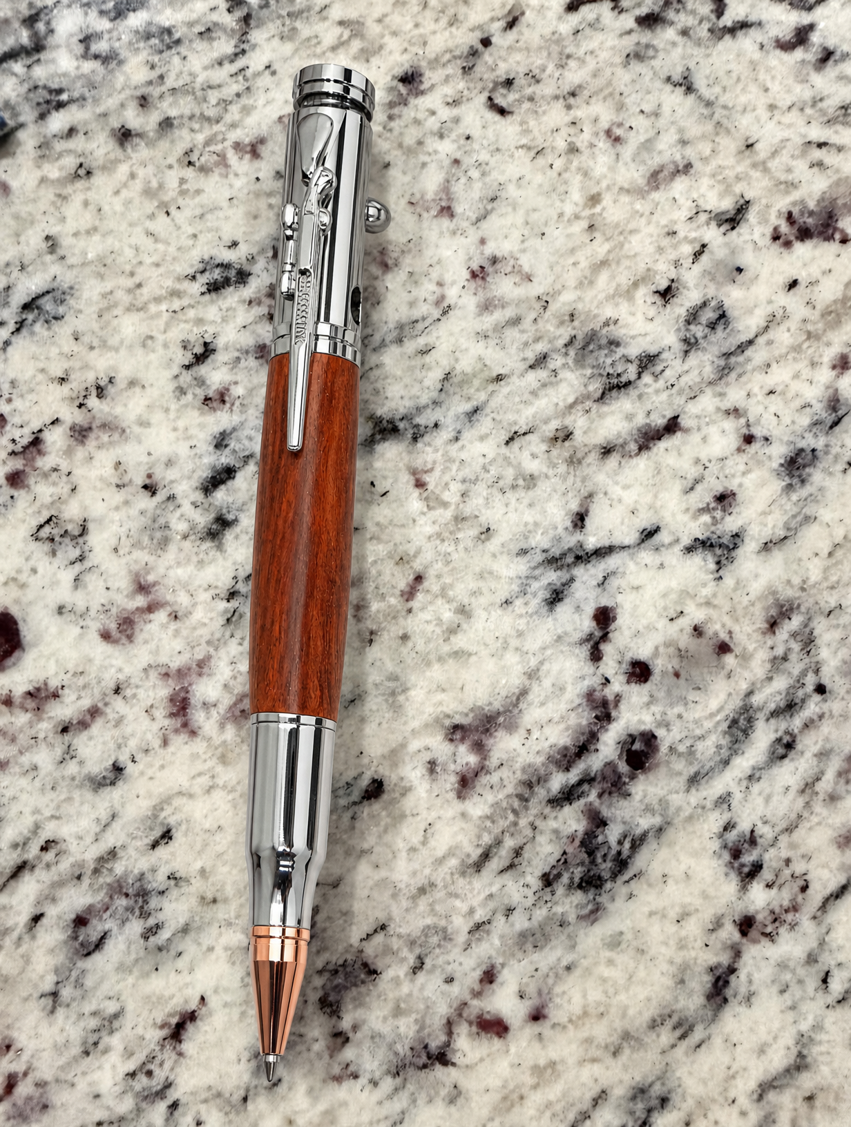Silver decorative pen on a stone counter