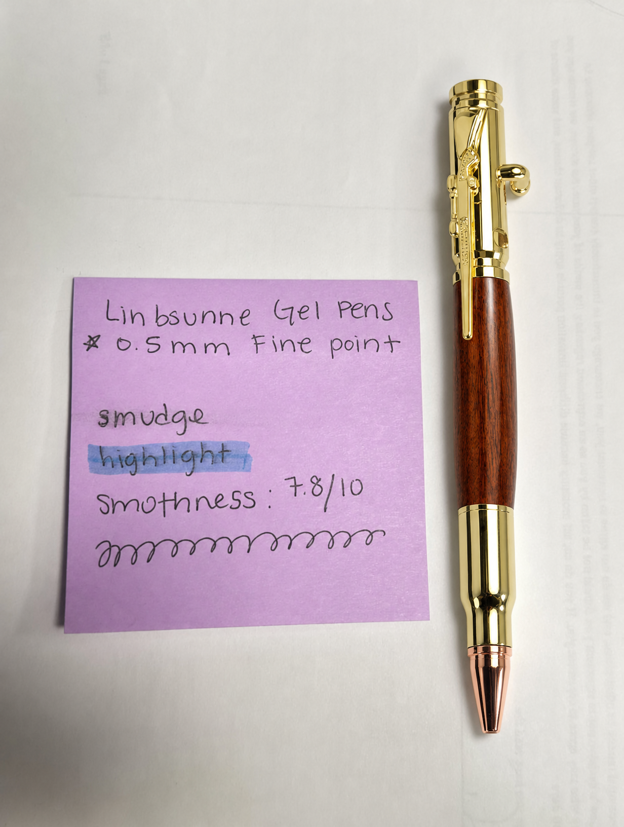 Gold pen beside a handwritten writing test