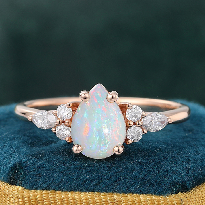 Classic Pear Opal Engagement Ring with Diamond Cluster Accents