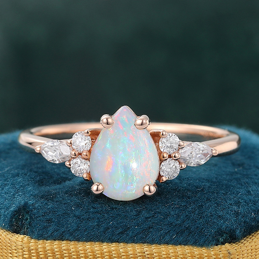 Classic Pear Opal Engagement Ring with Diamond Cluster Accents