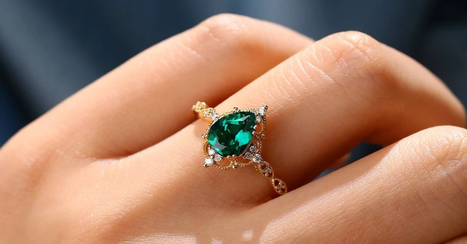 green emerald engagement ring