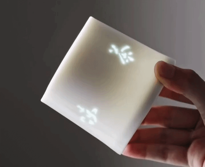 Rotating Linglong porcelain mug, light passing through the carved apertures