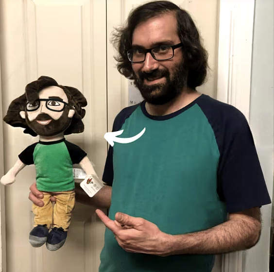 Man Holding a Lookalike Plush Doll