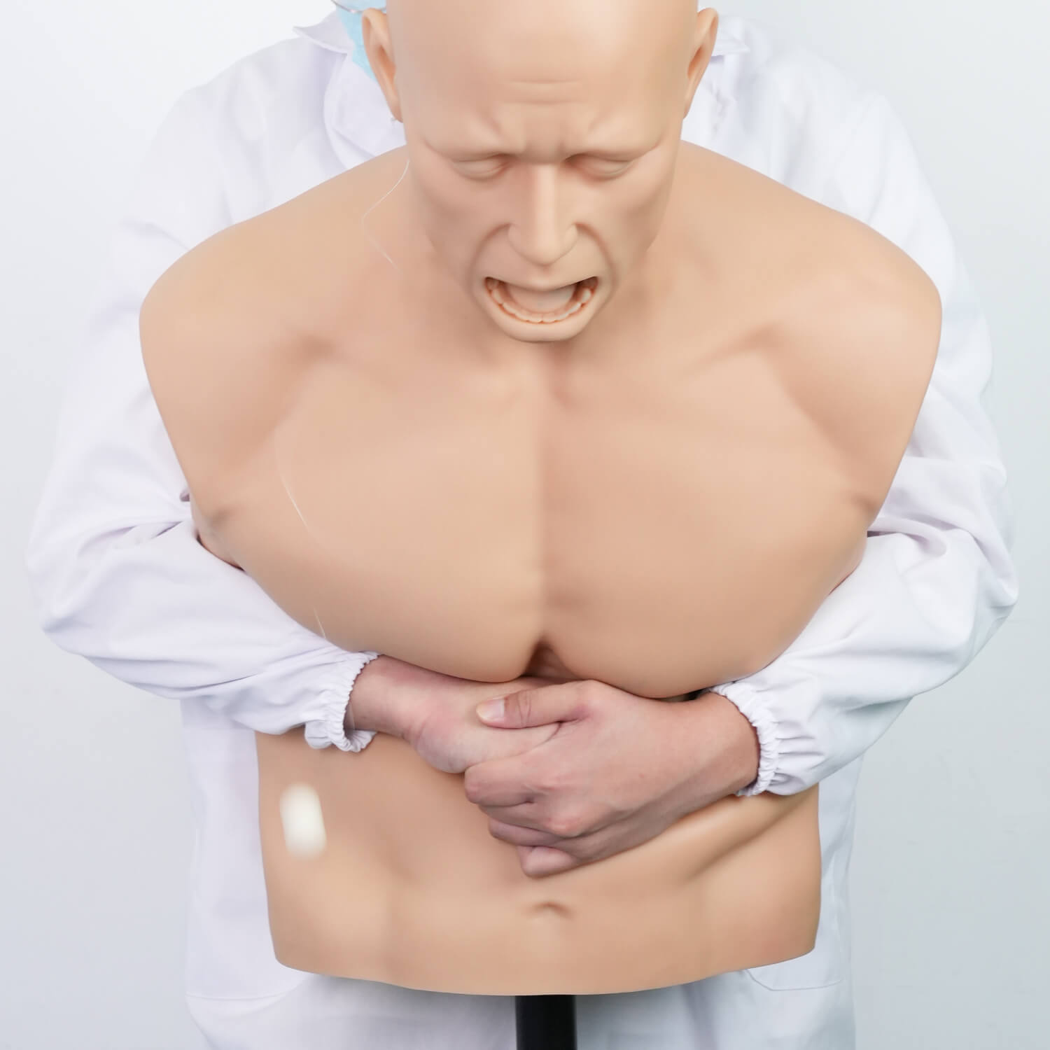 Adult choking training manikin demonstrating abdominal thrust hand placement