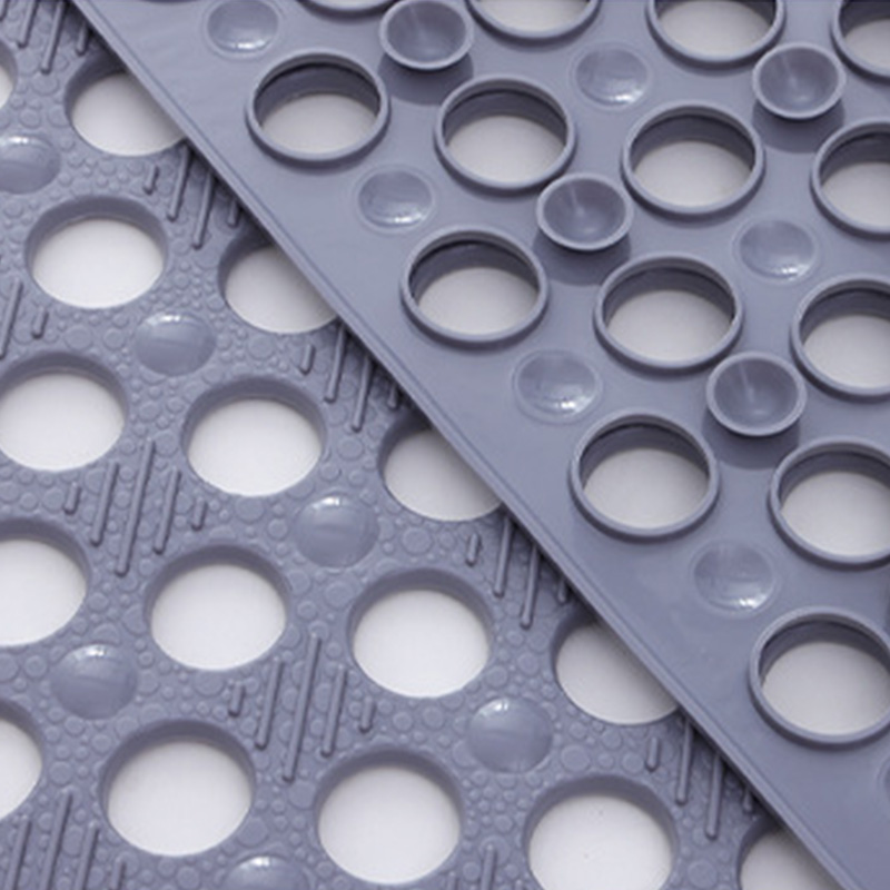 Suction cups and textured shower mat surface