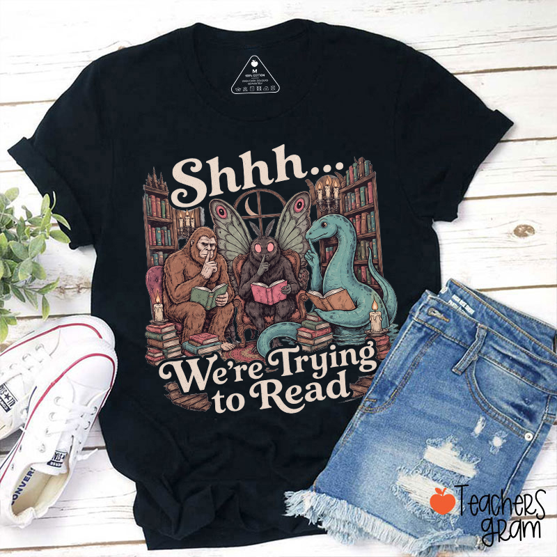 Shhh We're Trying To Read Cryptid Library Reading Graphic Teacher T-Shirt