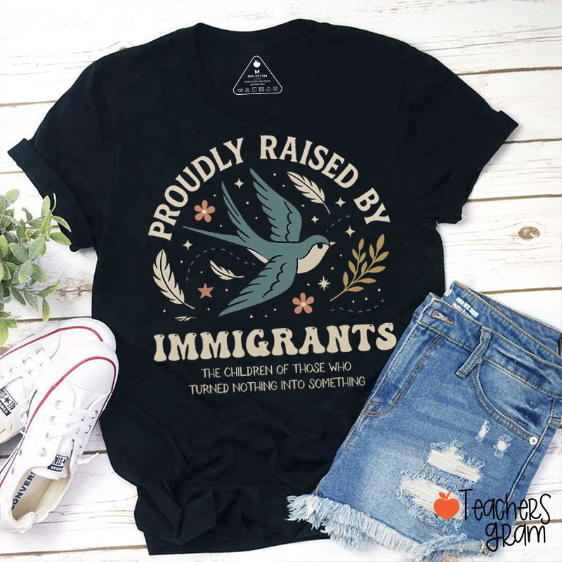 Proudly Raised By Immigrants Teacher T-Shirt
