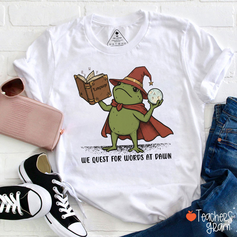 We Quest For Words At Dawn Wizard Frog Teacher T‑Shirt