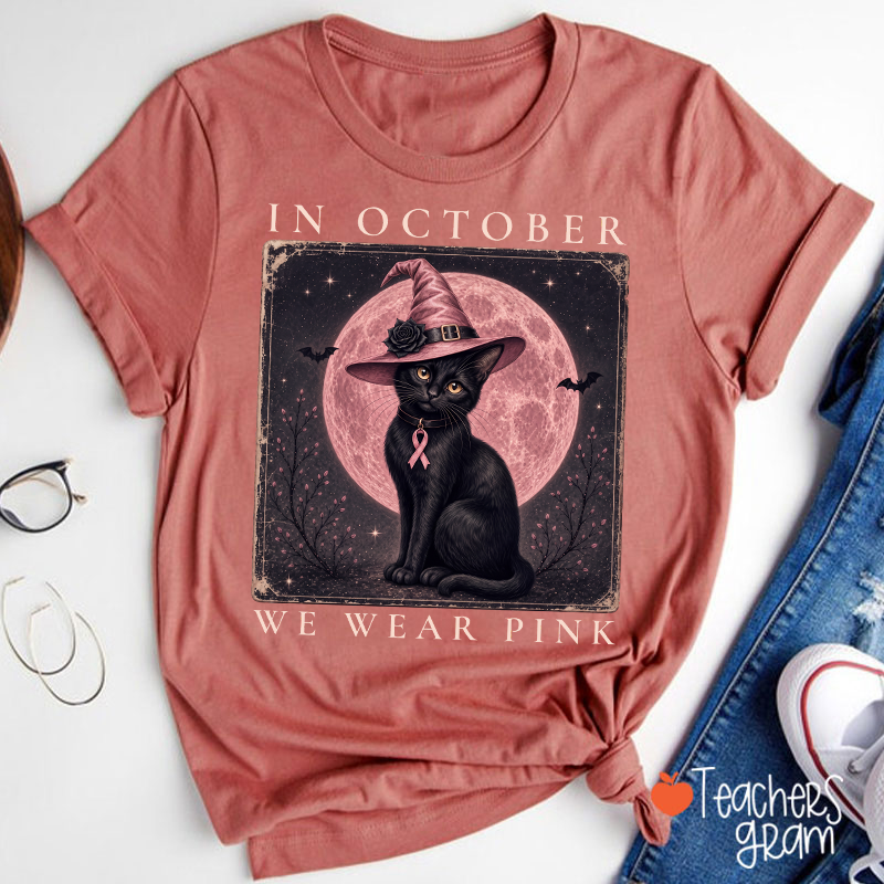 In October We Wear Pink Witch Black Cat Pink Moon Breast Cancer Awareness Teacher T‑Shirt