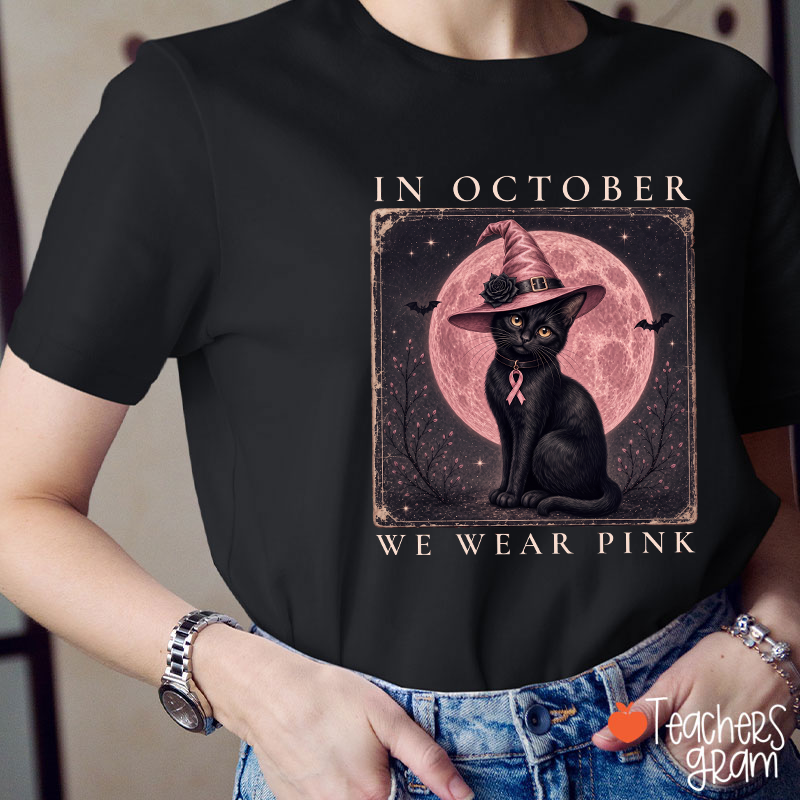 In October We Wear Pink Witch Black Cat Pink Moon Breast Cancer Awareness Teacher T‑Shirt