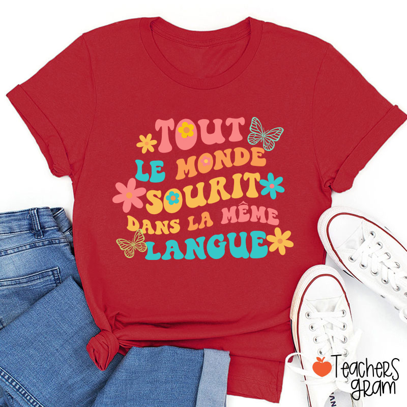 Tout Le Monde Sourit Dans La Même Langue French Teacher T-Shirt