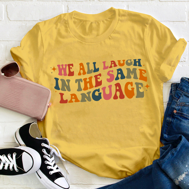 We All Laugh in the Same Language Teacher T-Shirt