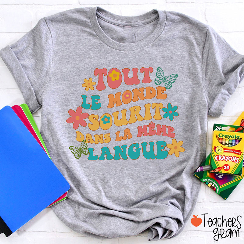 Tout Le Monde Sourit Dans La Même Langue French Teacher T-Shirt