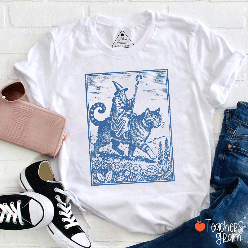 Wizard Riding A Cat Through A Flowered Field Teacher T-Shirt