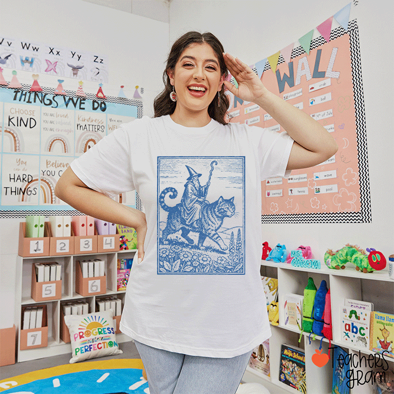 Wizard Riding A Cat Through A Flowered Field Teacher T-Shirt