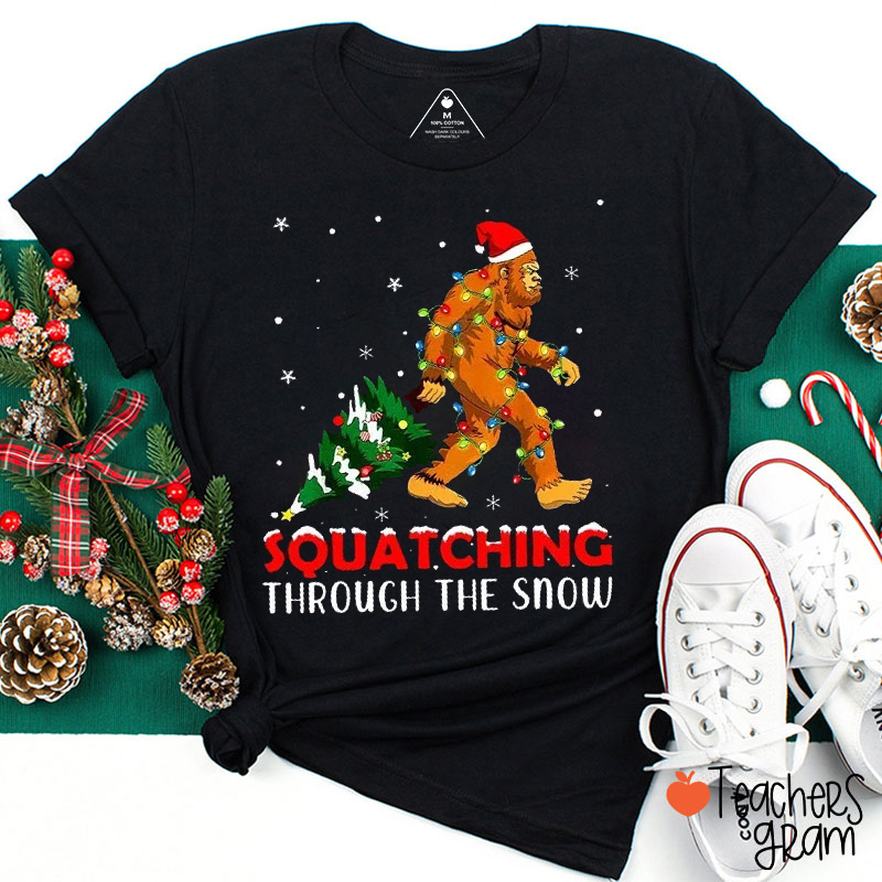Squatching Through The Snow Teacher T-Shirt