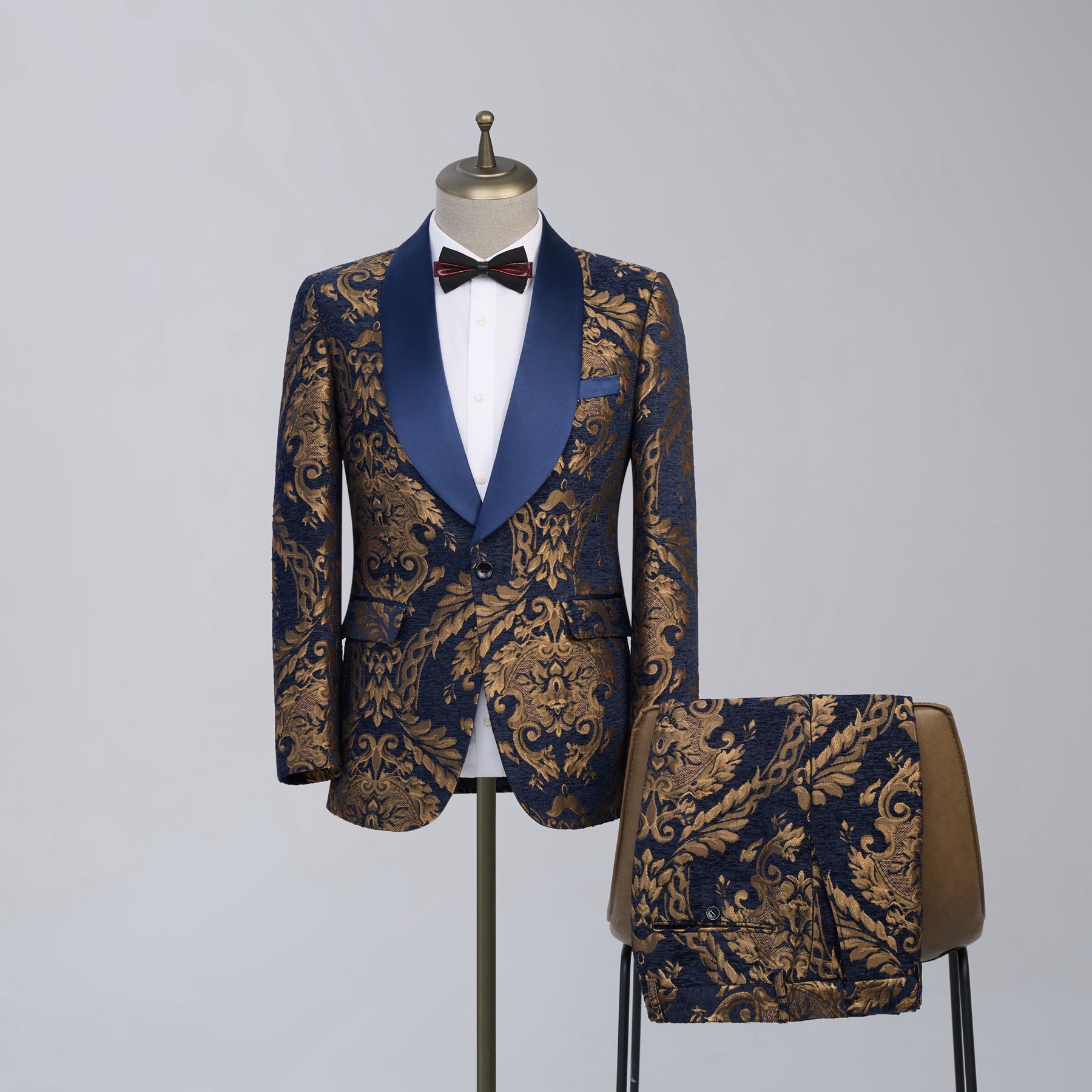 Men's navy blue and gold baroque jacquard suit jacket with a satin blue shawl lapel and matching trousers.