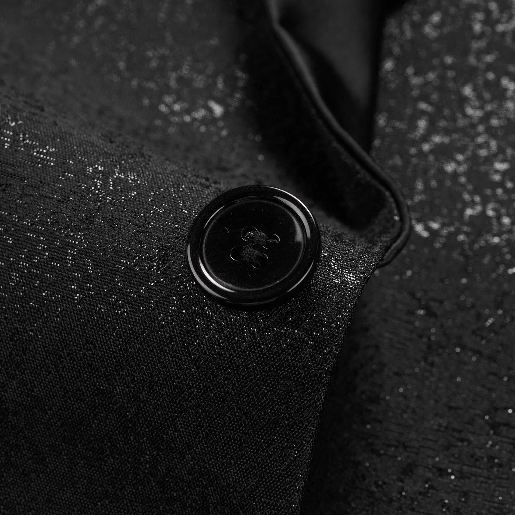 Front view of a men's shimmer black tuxedo jacket with a satin shawl lapel, one button closure, and textured fabric.