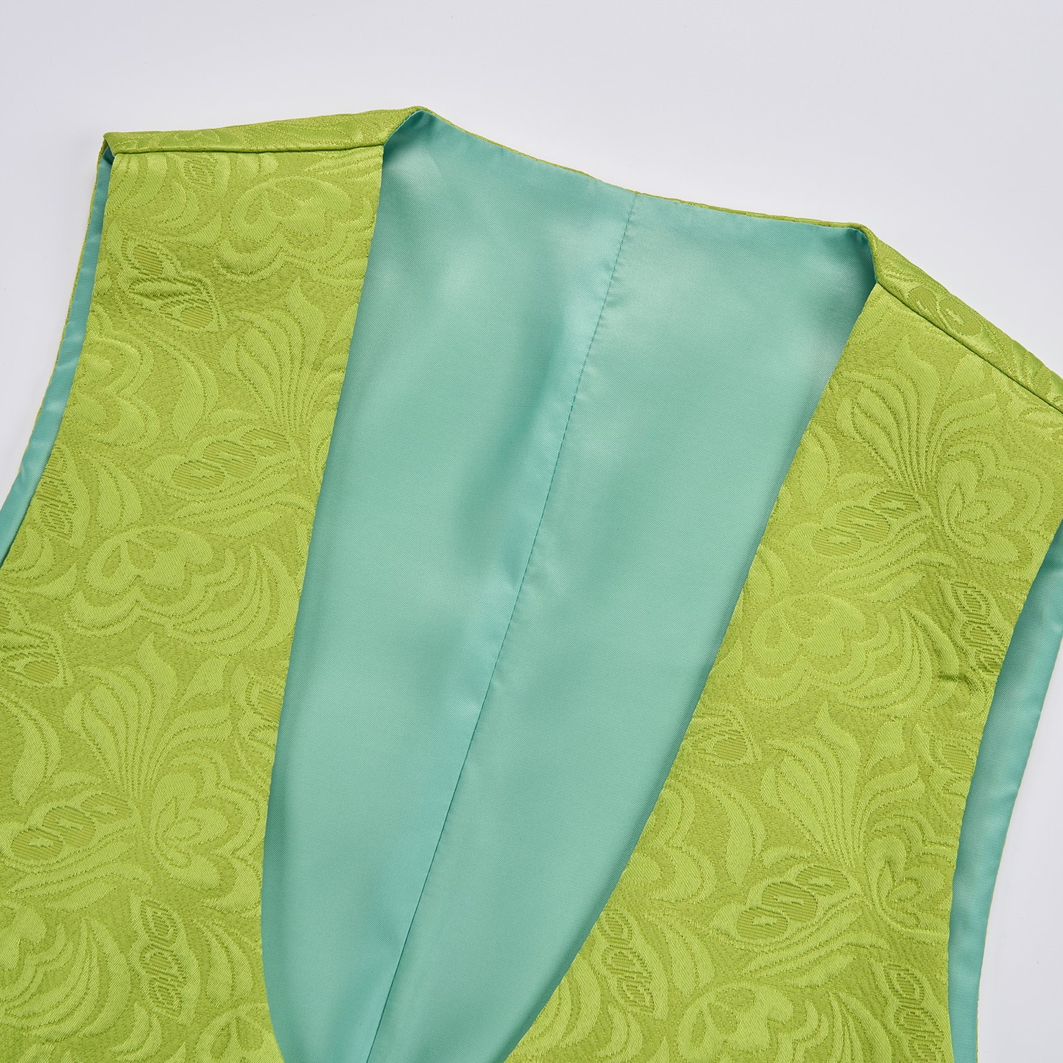 Front view of a men's lime green brocade 3-piece suit with black velvet shawl lapel and matching vest.