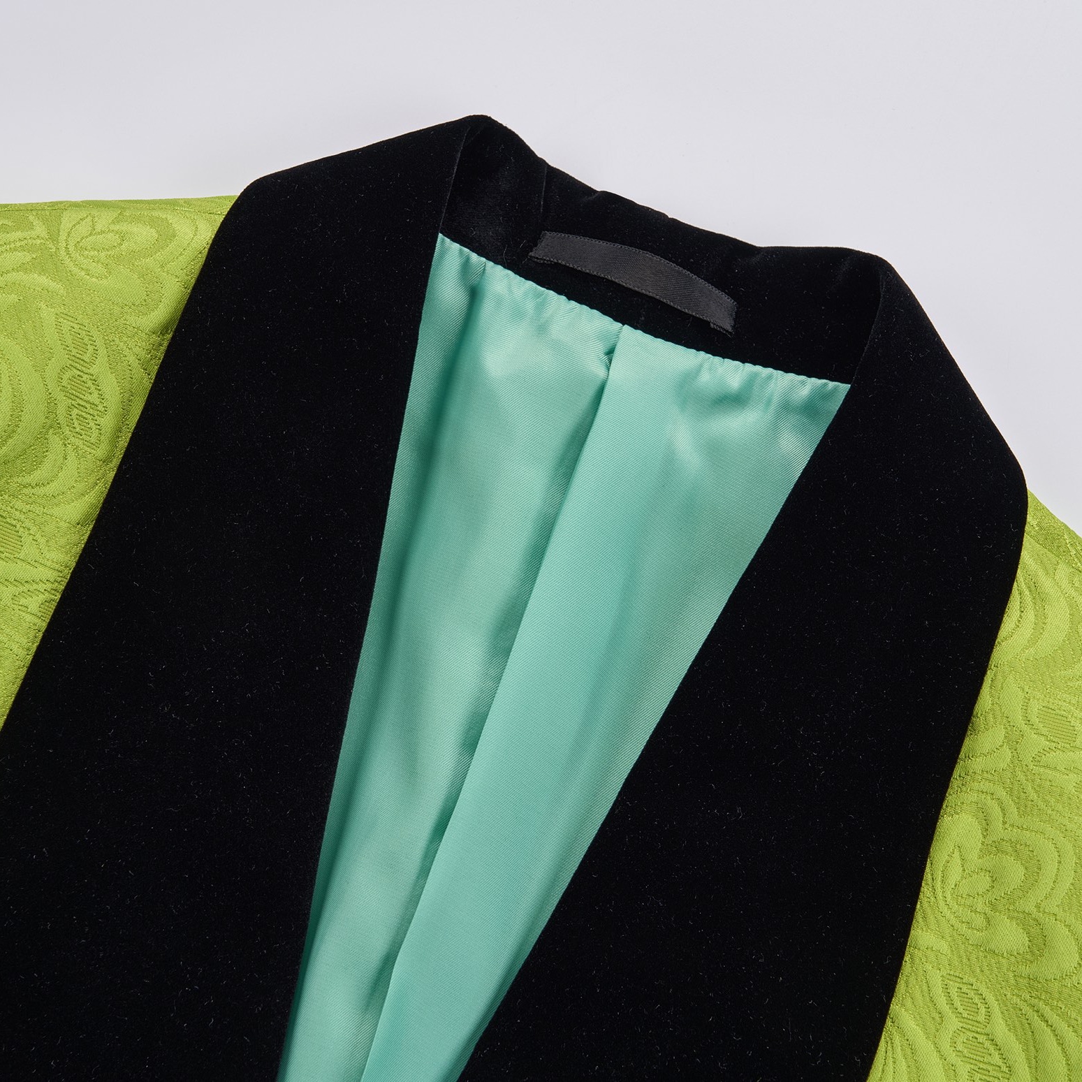Front view of a men's lime green brocade 3-piece suit with black velvet shawl lapel and matching vest.