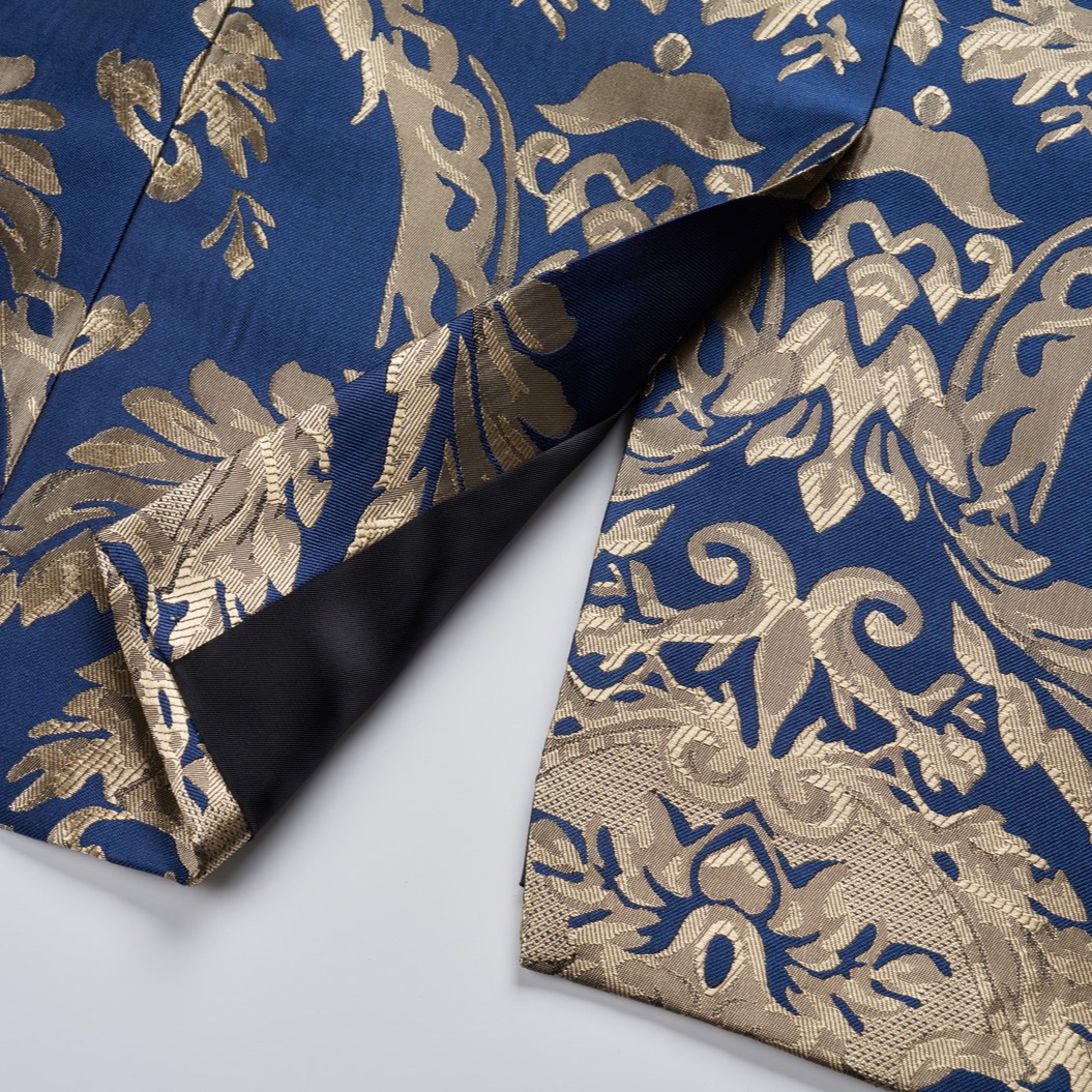 Front view of a men's blue and gold damask patterned blazer with black shawl lapels, one-button closure, and black trim