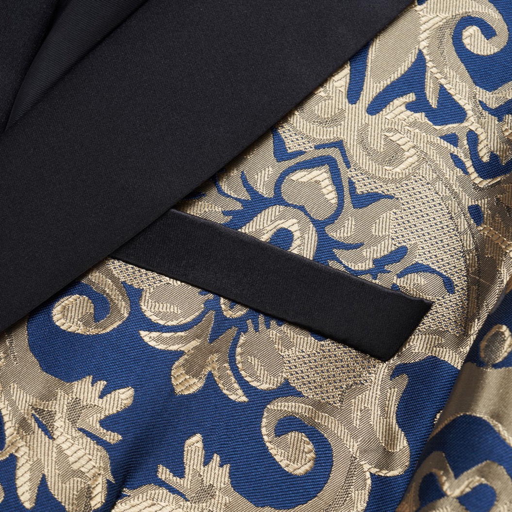 Front view of a men's blue and gold damask patterned blazer with black shawl lapels, one-button closure, and black trim