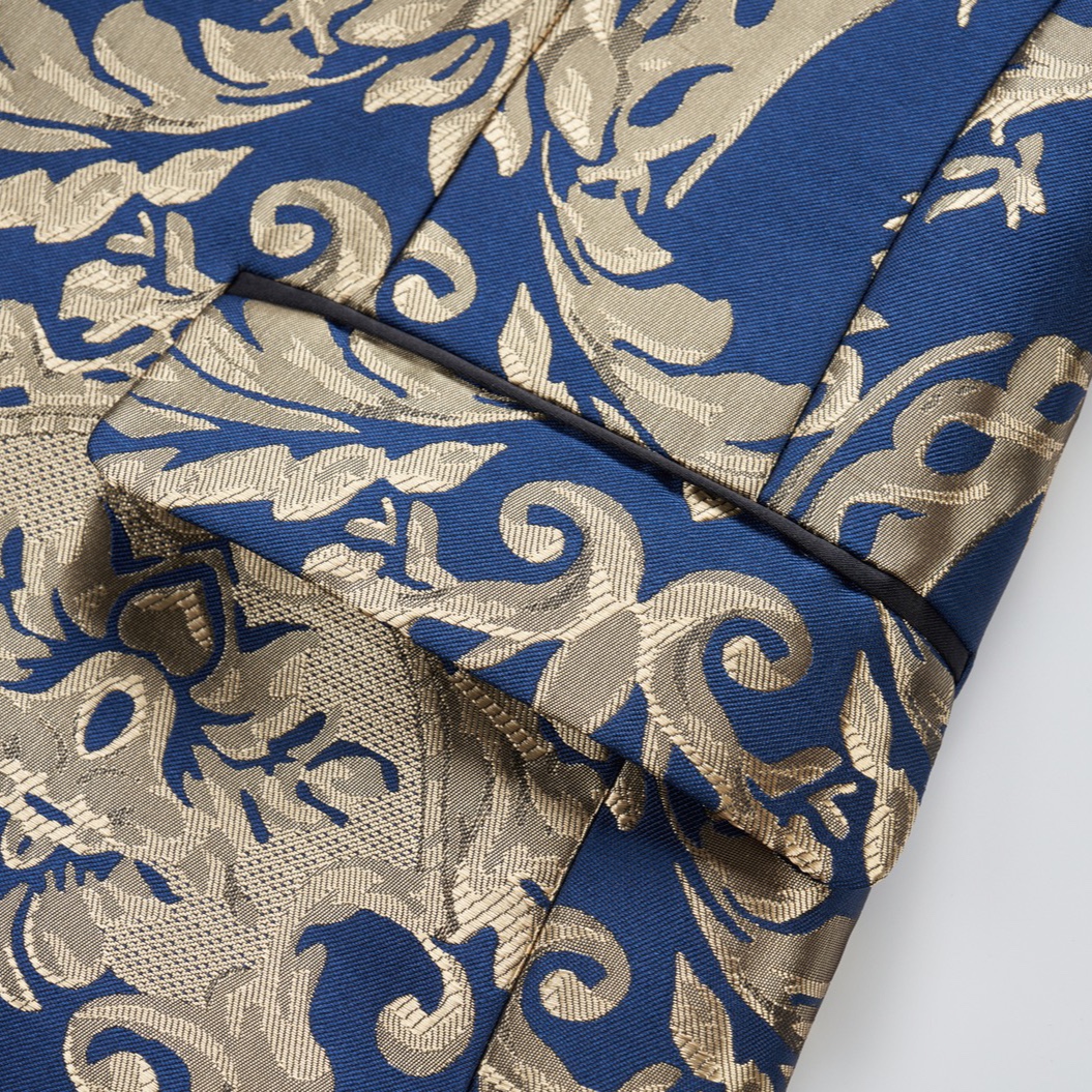 Front view of a men's blue and gold damask patterned blazer with black shawl lapels, one-button closure, and black trim