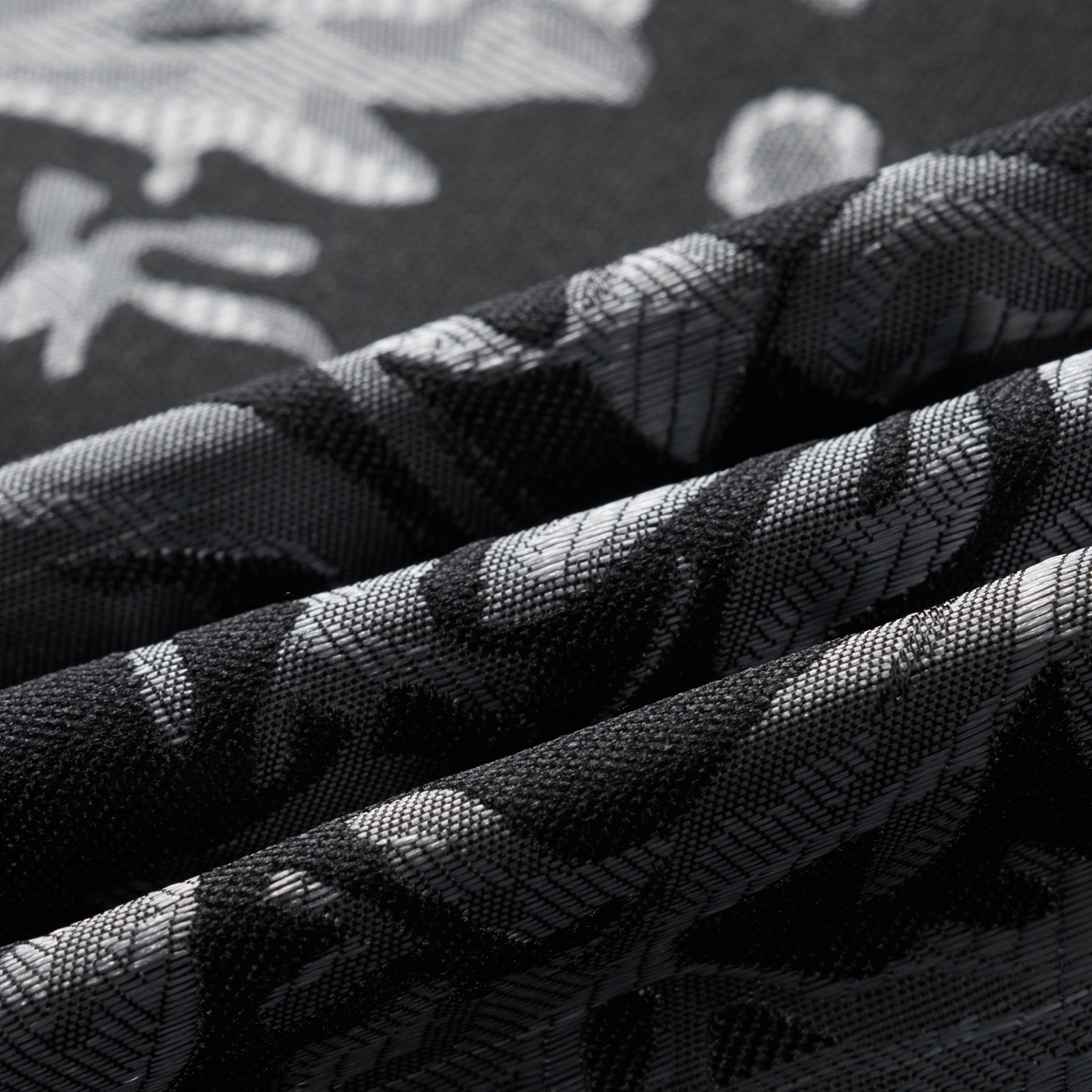 Front view of a men's black suit jacket with silver damask pattern and black satin shawl lapels.