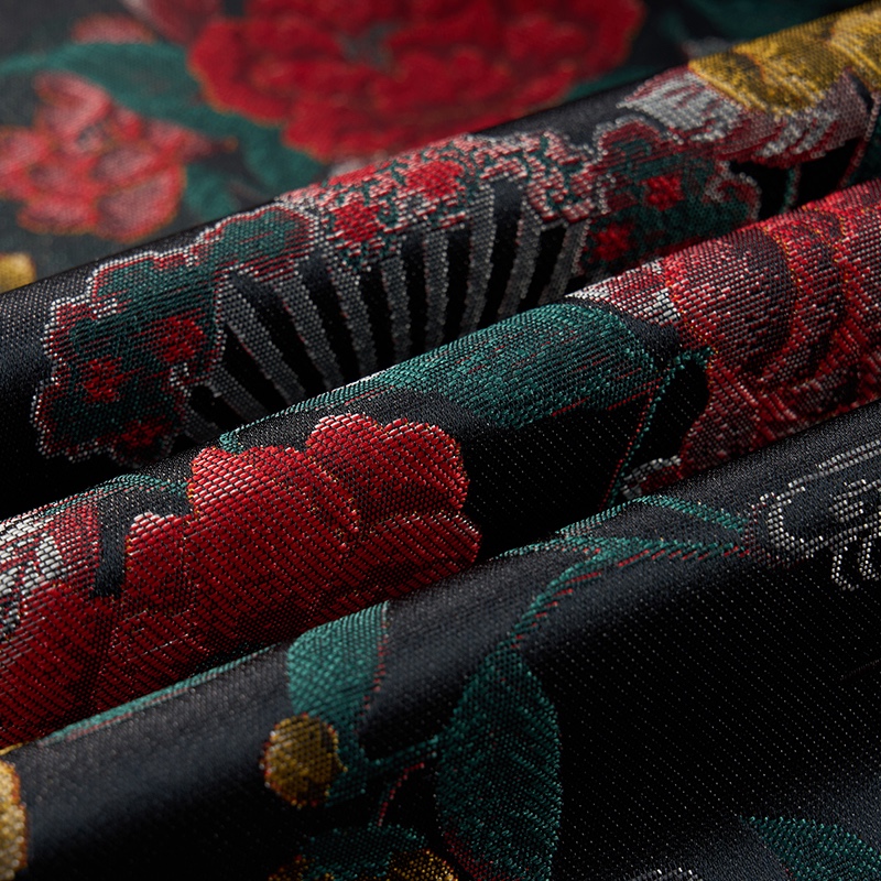 Front view of a men's dark floral jacquard blazer with red, yellow, and green flowers and fan motifs.