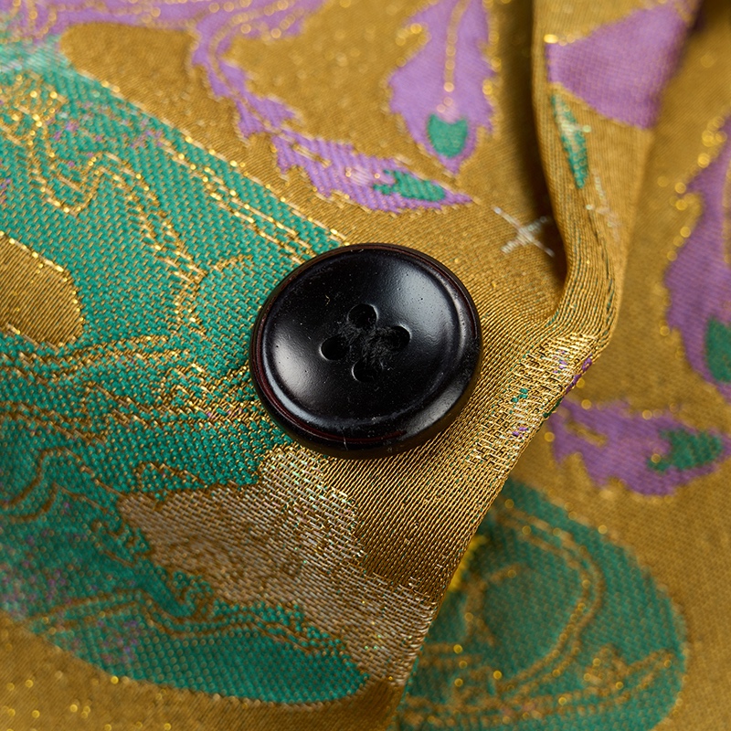 Front view of a men's gold jacquard blazer with green and purple mythical creature patterns, featuring a single black button