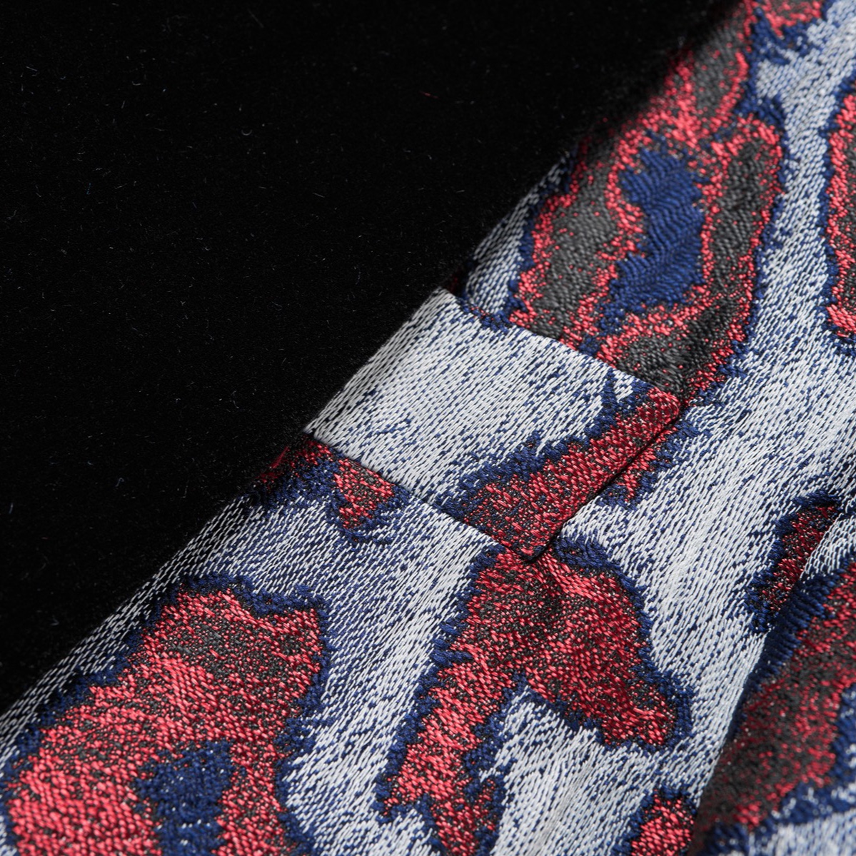 Front view of a men's red, blue, and silver leopard print jacquard blazer with a black velvet shawl lapel and a single-button