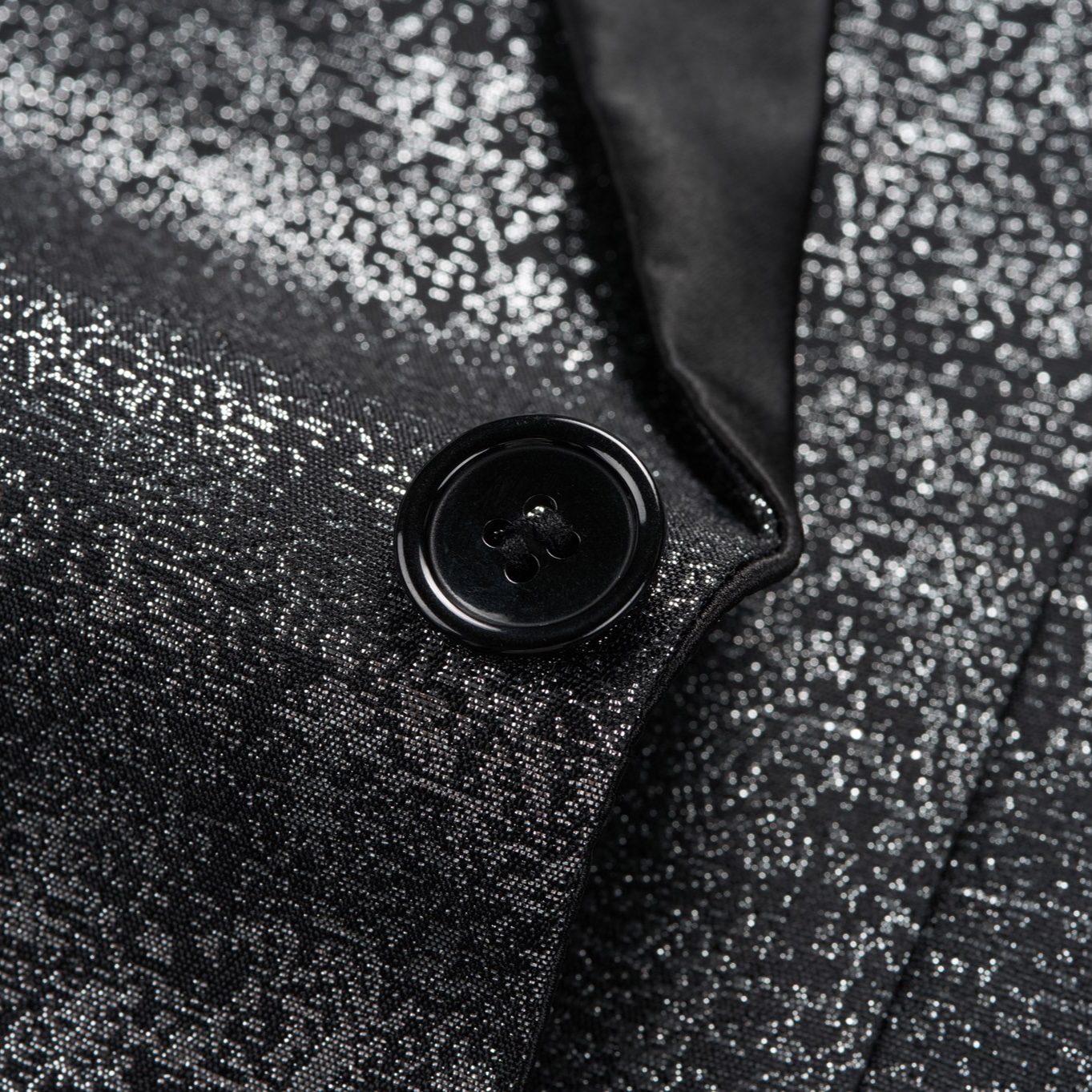 Front view of a men's sparkling black glitter tuxedo jacket with black satin peak lapels and one button closure.