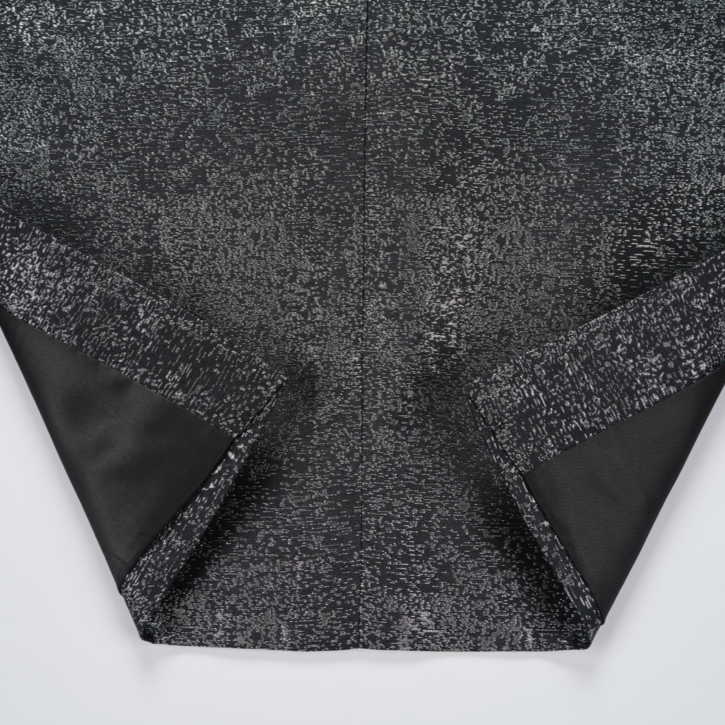 Front view of a men's sparkling black glitter tuxedo jacket with black satin peak lapels and one button closure.
