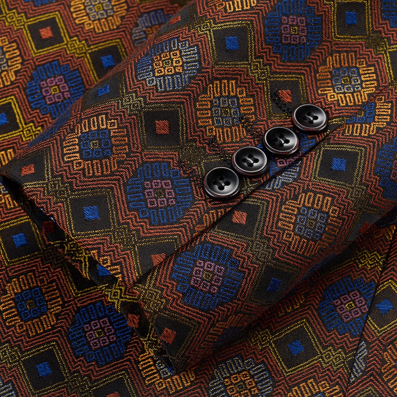 Front view of a men's brown, blue, and orange geometric jacquard blazer with one button closure.
