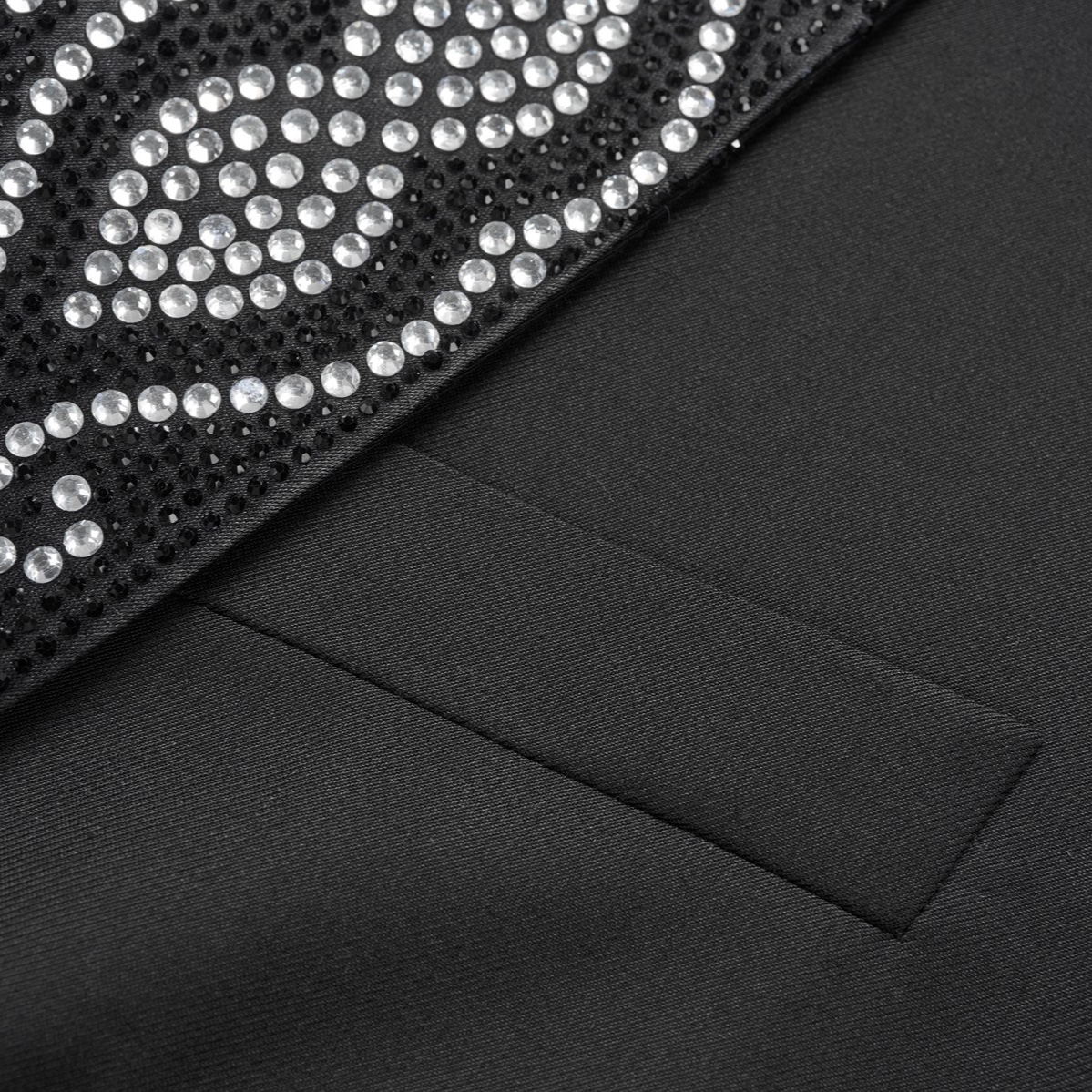 Front view of a men's black double-breasted tuxedo jacket with sequin-embellished shawl lapels, scattered rhinestones on the
