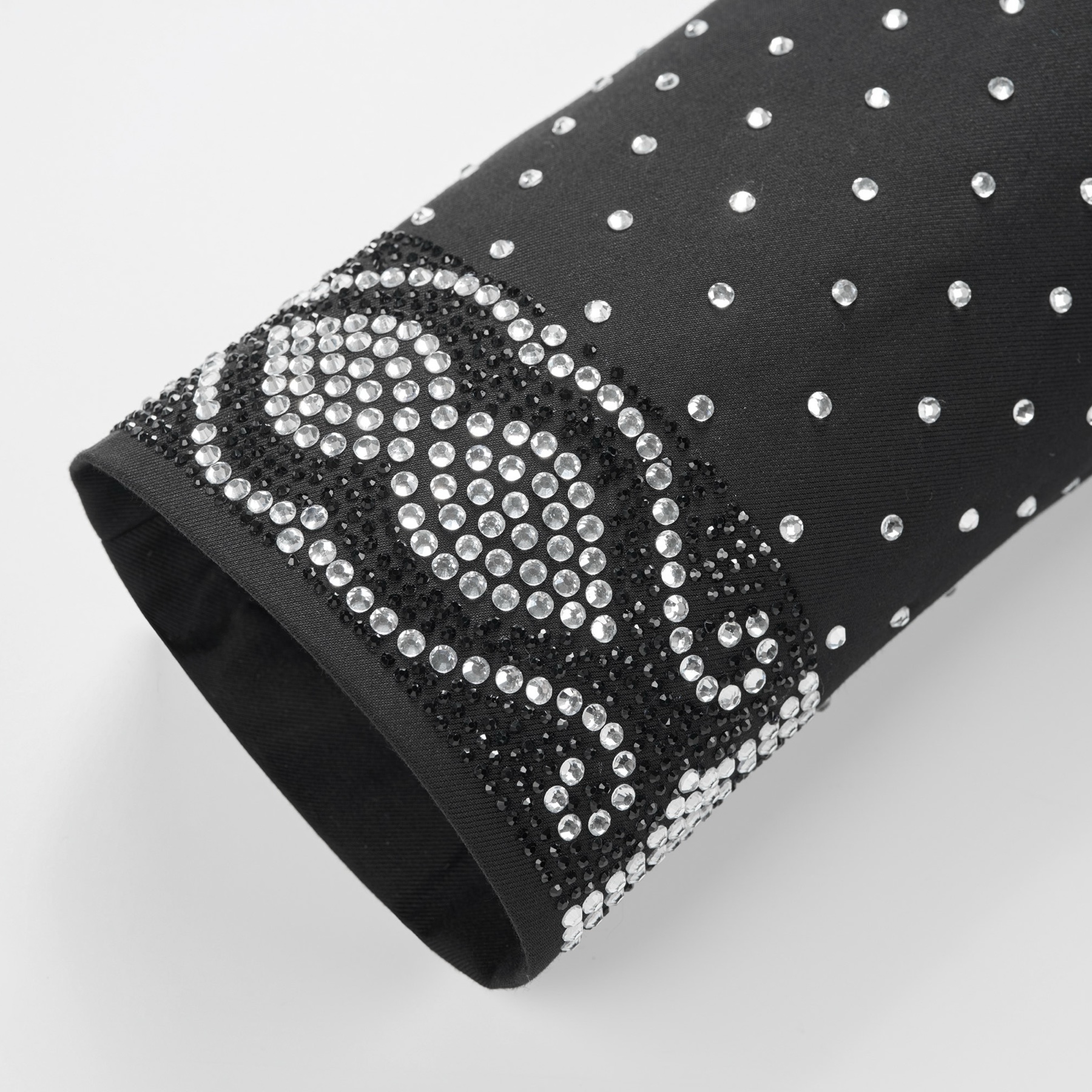 Front view of a men's black double-breasted tuxedo jacket with sequin-embellished shawl lapels, scattered rhinestones on the