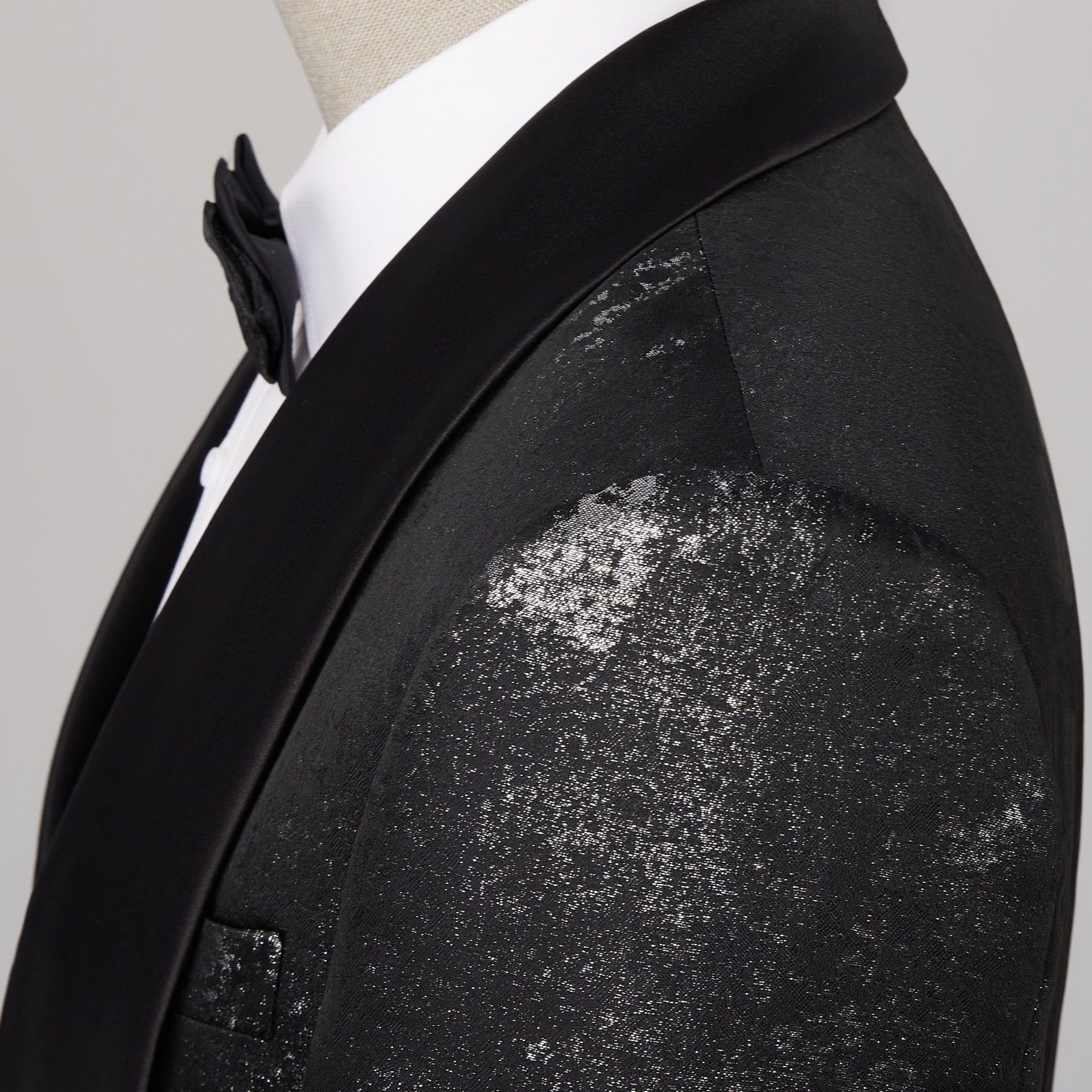 Back view of a men's black suit jacket with silver distressed metallic print