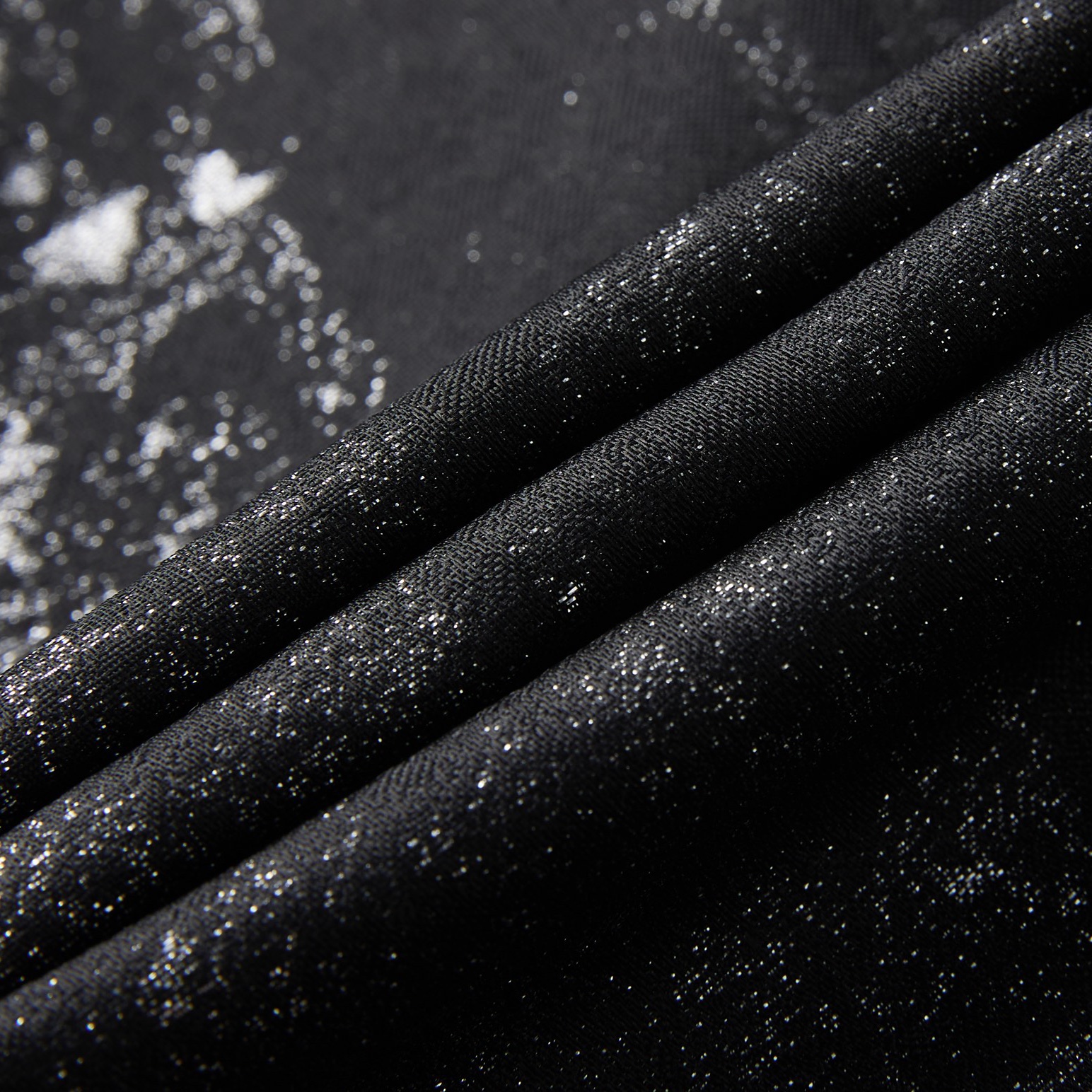 Back view of a men's black suit jacket with silver distressed metallic print