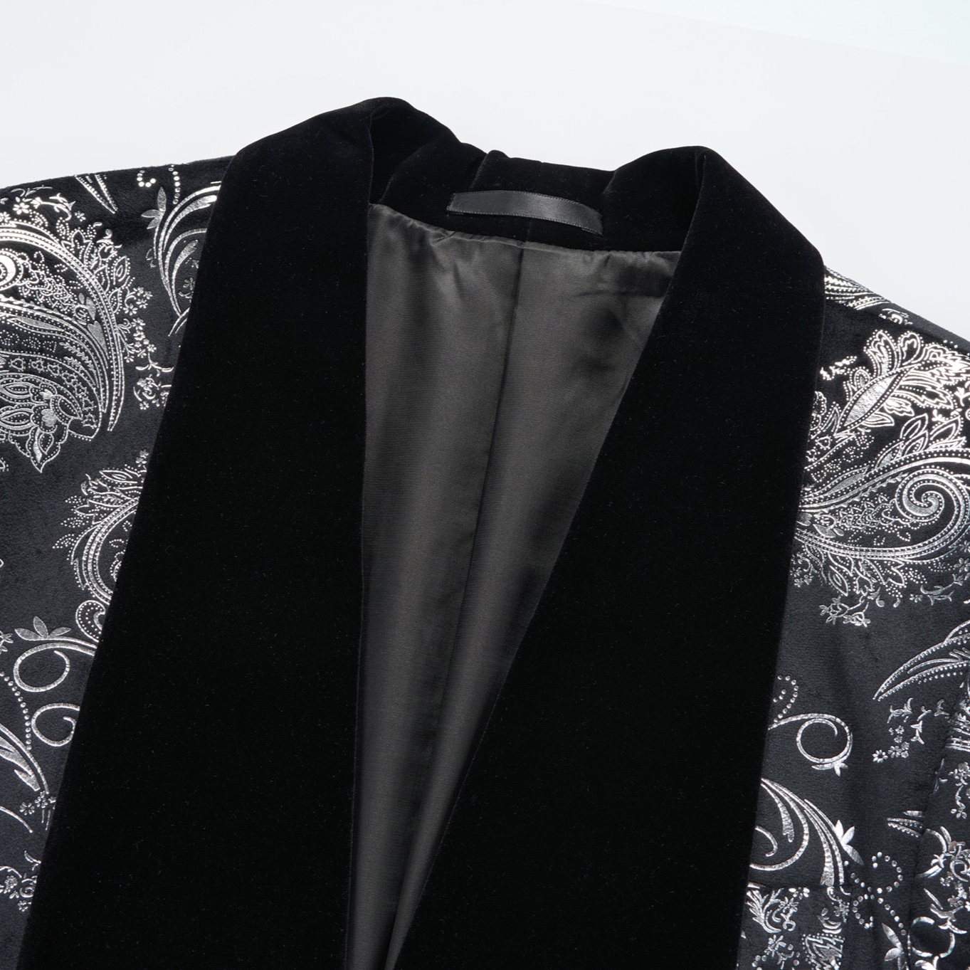 Front view of a men's black blazer with silver paisley pattern and black velvet shawl lapel.