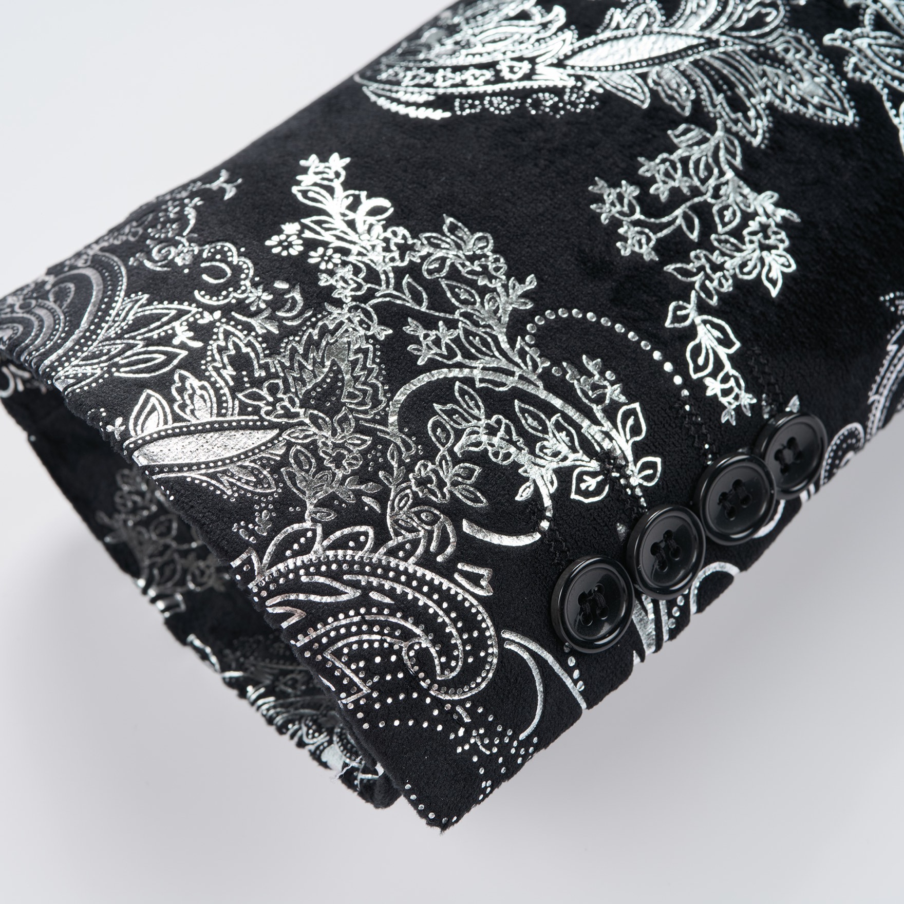 Front view of a men's black blazer with silver paisley pattern and black velvet shawl lapel.