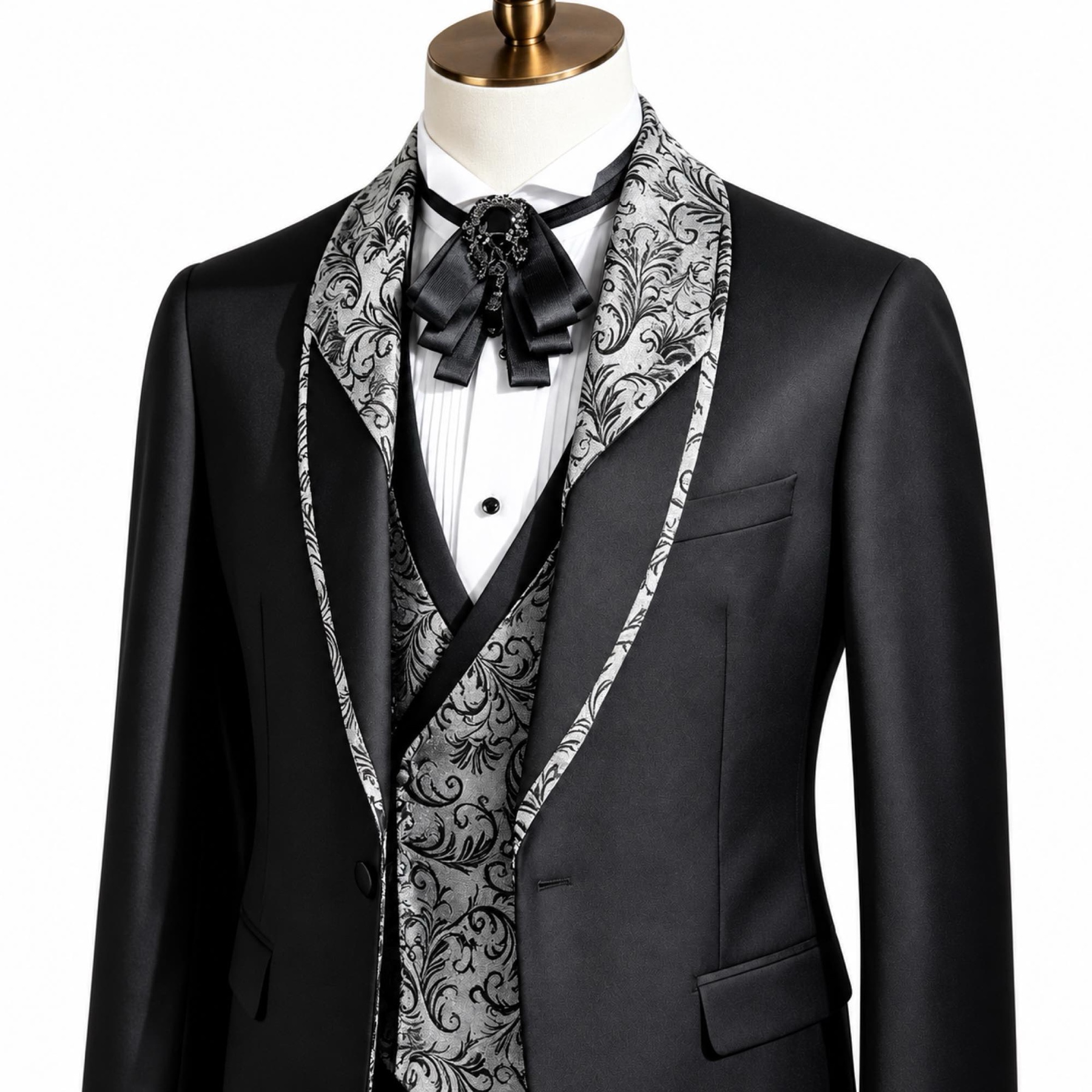 Black men's 3-piece tuxedo suit with silver and black patterned shawl lapel and matching vest, worn on a mannequin.