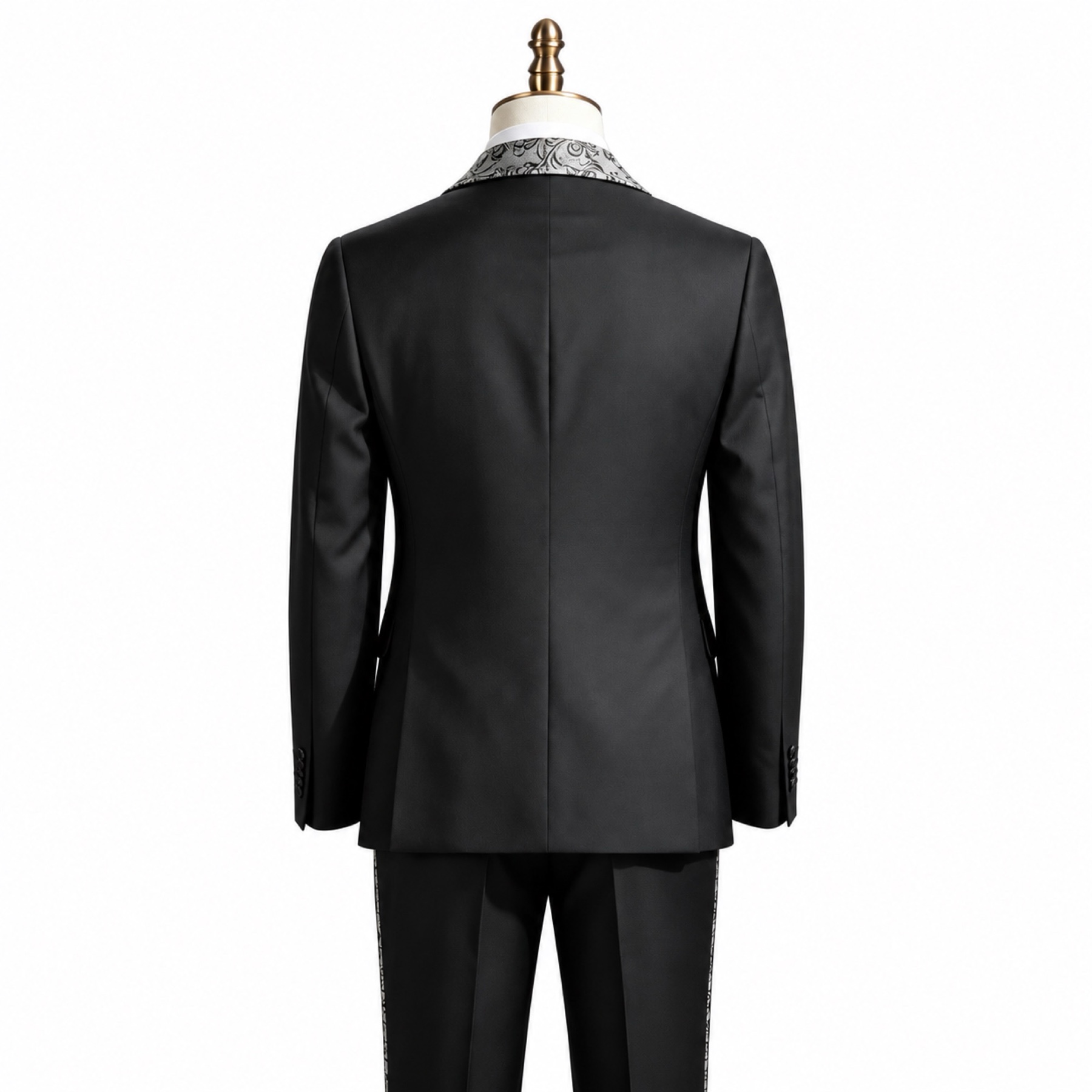 Black men's 3-piece tuxedo suit with silver and black patterned shawl lapel and matching vest, worn on a mannequin.
