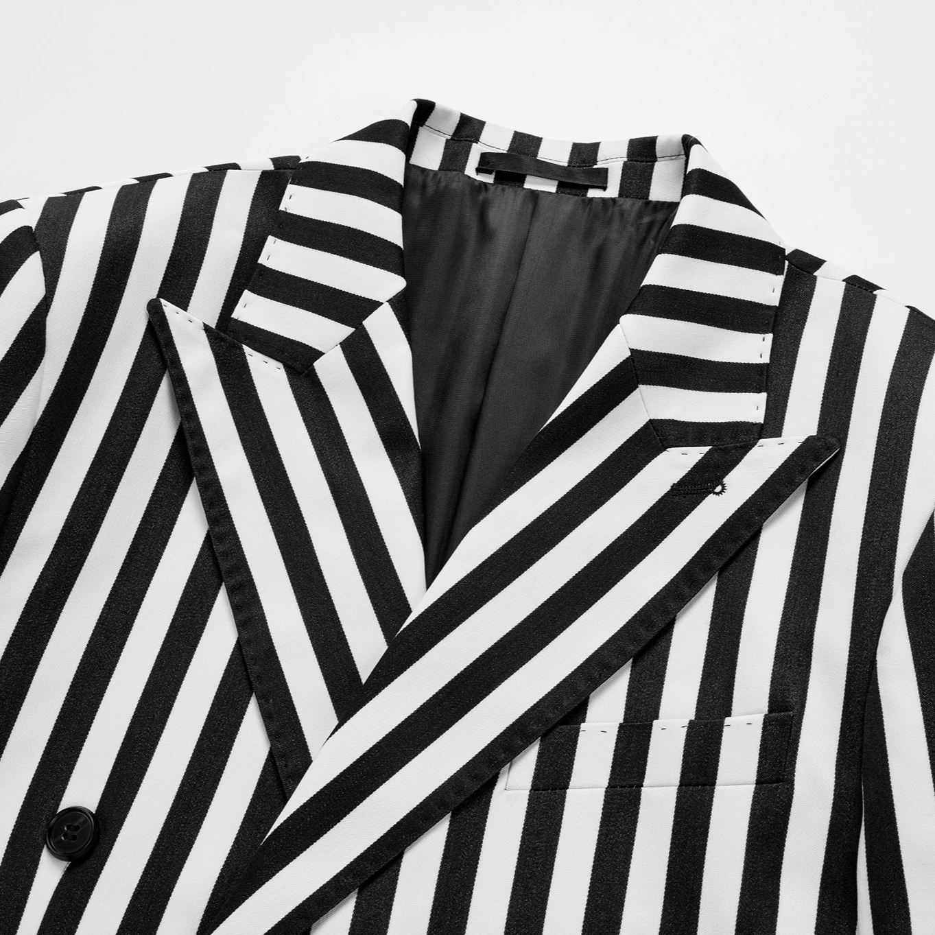 Close-up of a men's black and white striped double-breasted suit with peak lapels and button details.