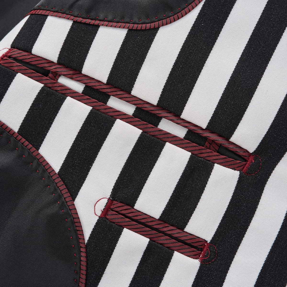 Close-up of a men's black and white striped double-breasted suit with peak lapels and button details.