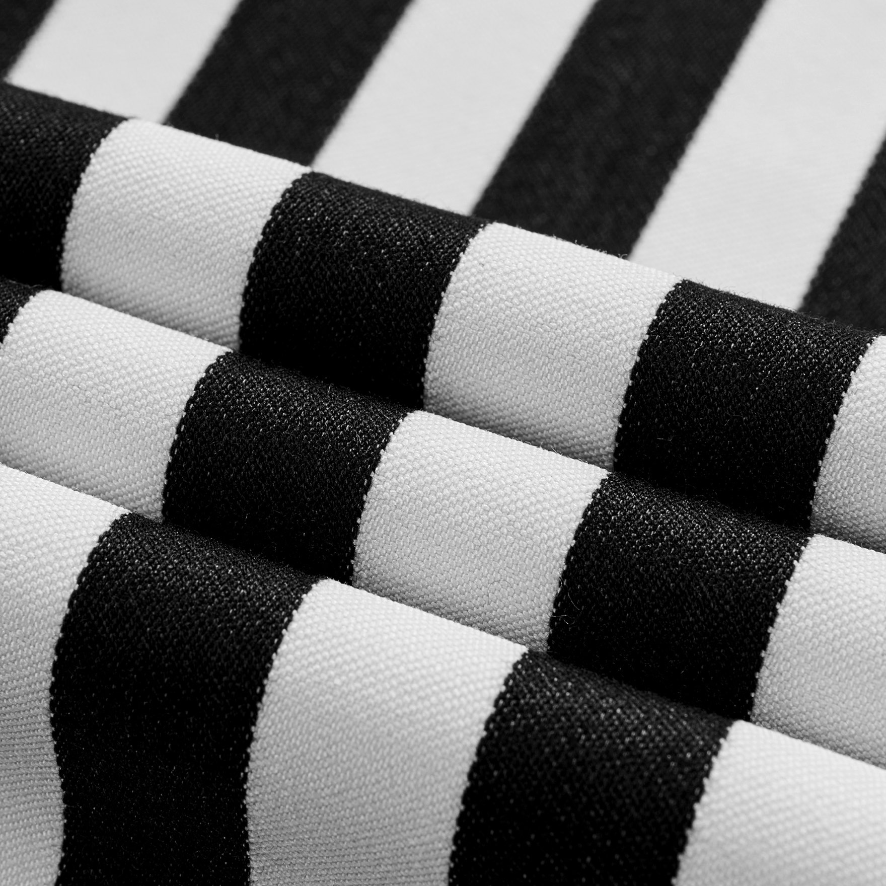 Close-up of a men's black and white striped double-breasted suit with peak lapels and button details.