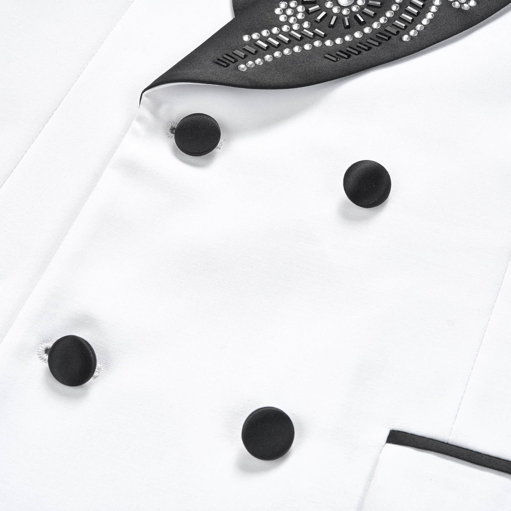 Front view of a white double-breasted suit jacket with black embellished shawl lapels and cuffs featuring rhinestones and