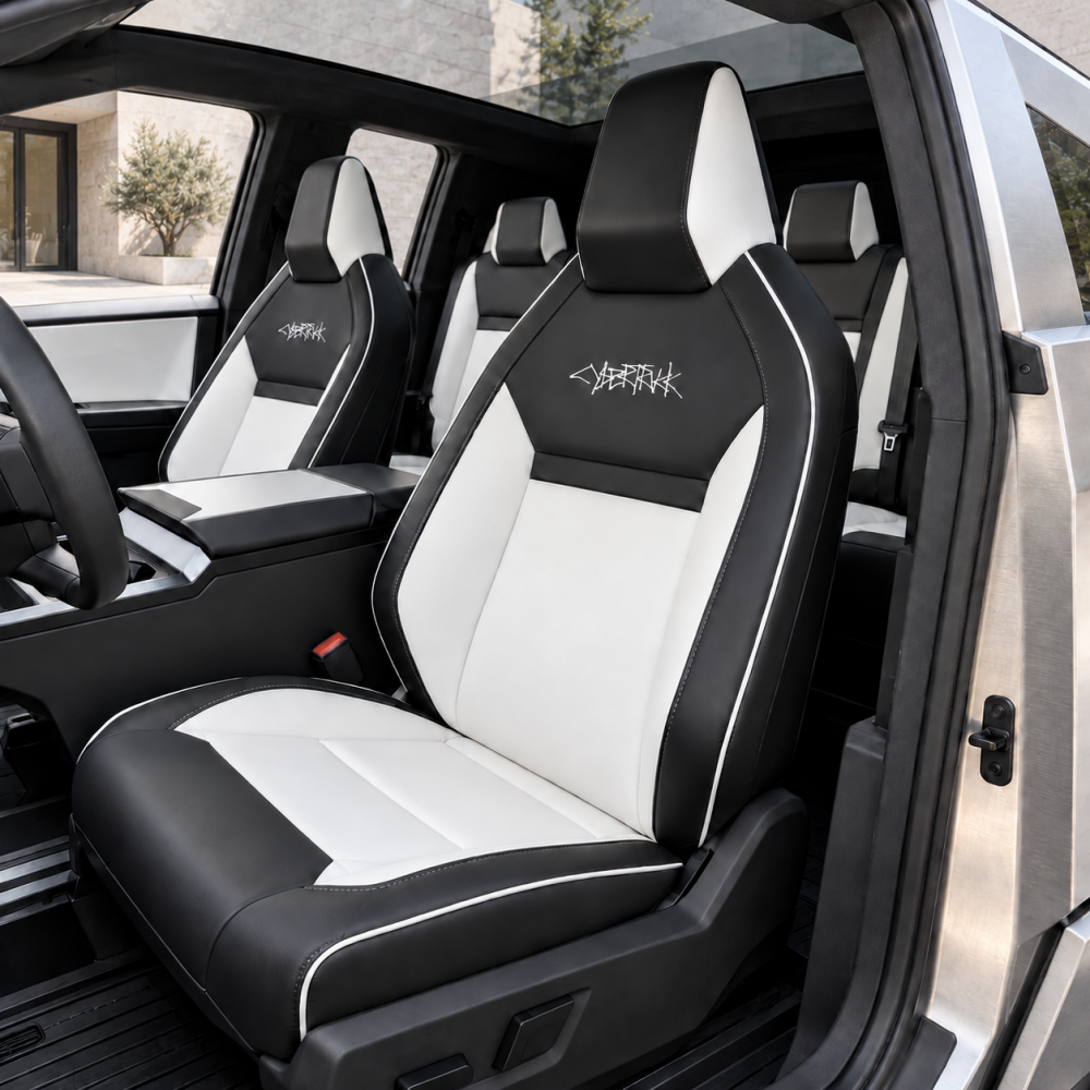 Black and white Cybertruck seat covers installed across front and rear seats