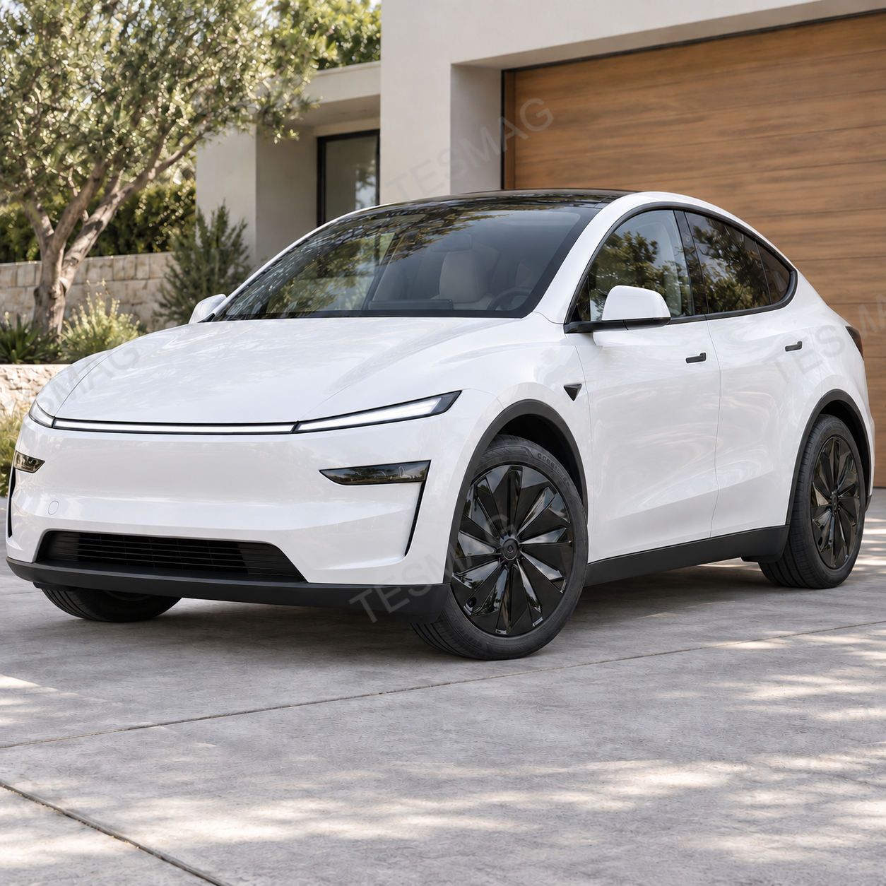 White Tesla Model Y Juniper front three-quarter view with gloss black wheel covers