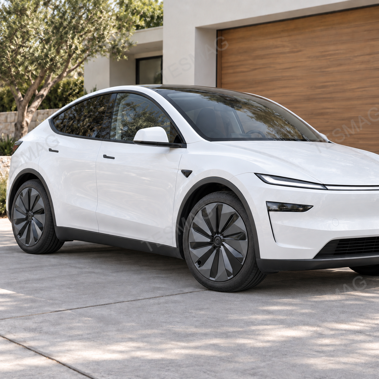 White Tesla Model Y Juniper with gray-black two-tone 19-inch wheel covers